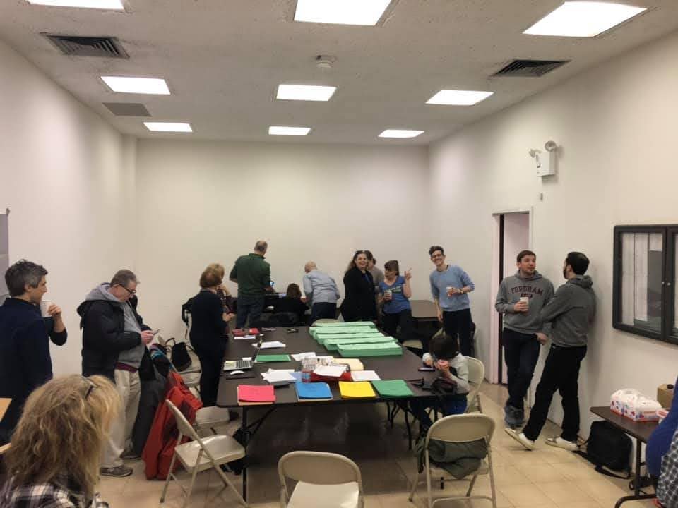 People in a room collecting petitions
